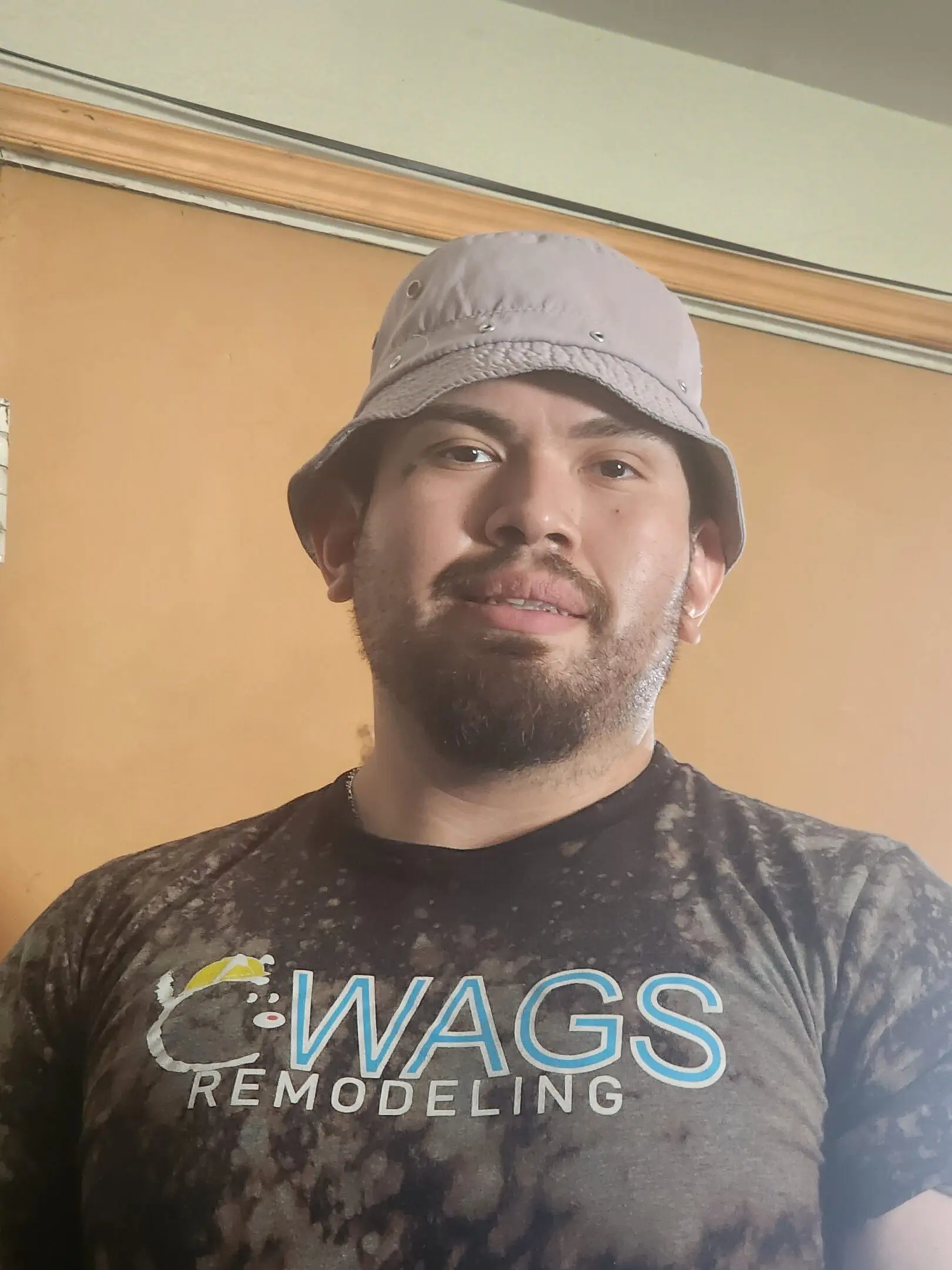 A man wearing a hat and shirt with words on it.